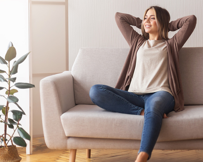 Woman on a couch in a therapy session for infertility support